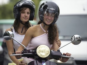 Two woman riding a scooter, Barcelona, Spaina