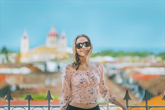 Happy young woman on vacation in Granada city, Nicaragua. Portrait of a beautiful tourist girl with