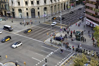 Crossroads with cars, taxis, pedestrians, view from above, Passeig de Gracia, Barcelona, Spain,