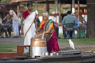 Tealady, 83 years old, making Indian tea on her boat, Backwaters, Kumarakom, Kerala, India, Asia