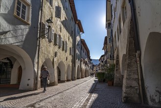 The town of Neumarkt, in the Adige Valley, in South Tyrol, arcades in the old town centre, in front