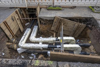 Construction site of a district heating house connection, pipes, insulated, are laid from a central