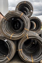 Steel wire, coils, waiting for further processing in the Rhine-Ruhr harbour in Mülheim an der Ruhr,