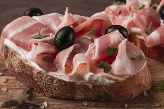 Breakfast, bacon and olives sandwich, on a cutting board, top view, close-up, no people