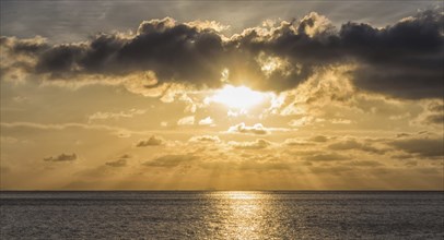 Sunset over the sea with the sun rays through the clouds, Malaysia, Asia