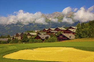 Crans Sur Sierre Golf Course with House and Mountain View in Crans Montana in Valais, Switzerland,