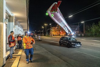 Transport of a 68 metre long, 22 tonne blade of a wind turbine, here in Schwelm, onlookers, with a