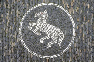 Jumping horse as a floor mosaic in Freiburg's historic city centre, Freiburg im Breisgau,