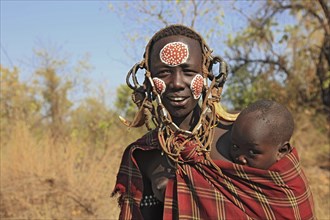 South Ethiopia, in Maco National Park, Mursi tribe, Mursi woman with baby, painted skin and