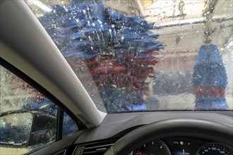 Car in an automatic car wash, car wash tunnel