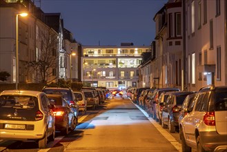 Residential street, many apartment buildings in a residential neighbourhood, evening, lantern