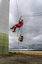 Height rescuers from the Oberhausen fire brigade practise abseiling from a wind turbine from a