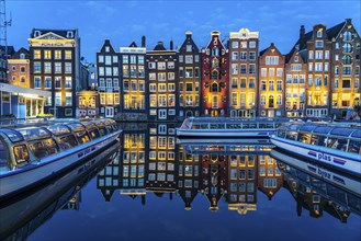 Canal houses on the Damrak, in the centre of the old town of Amsterdam, harbour, starting point of