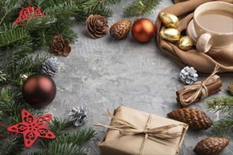 Christmas or New Year frame composition. Decorations, cones, cinnamon, fir and spruce branches, cup