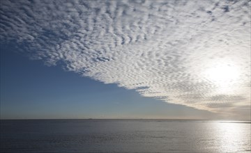 A mackerel sky or buttermilk sky of altocumulus clouds over Shingle Street, Suffolk, England,