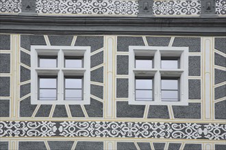 Renaissance house wall with two windows and sgraffiti, decorations, ornaments, grey, white, former