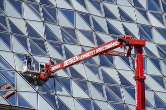 Building cleaners cleaning window panes, cleaning a facade, lorry working platform of the German