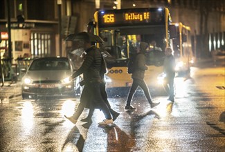 Passers-by at a pedestrian crossing, at the main railway station, rainy weather, city centre, in