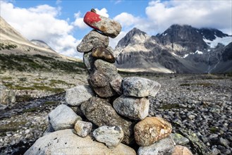 Cairn as signpost to glacier Lenangsbreen, at glacier lake Blavatnet, Blue water lake, Blavatn