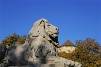 Resting lion made of granite on the terraced base of the equestrian statue of Emperor Wilhelm I on