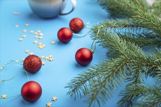 Christmas or New Year composition. Decorations, red balls, fir and spruce branches, cup of coffee,