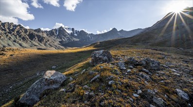 Autumnal high valley in atmospheric light, Keldike Valley on the way to the Ala Kul Pass, Sun Star,