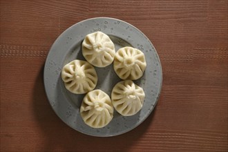 Overhead view of a plate with traditional Georgian dish khinkali stuffed with lamb of beef meat