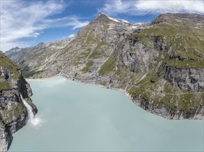 Panorama aerial view of lake Mauvoisin, artificial channels in the rock fill the lake, valley Val