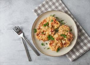 Steak, cauliflower, with cheese, spices, homemade, on a light gray table, close-up, top view,