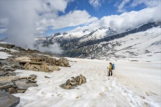 Mountaineer in a snowfield, descent from the summit of the Schönbichler Horn, view of snow-covered