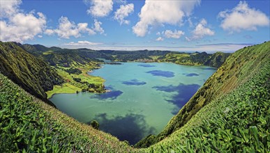 Panoramic view of the peaceful crater lake Lagoa Azul surrounded by lush crater rim, Lagoa Azul,