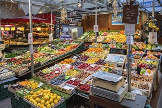 Market stall with a wide range of different tropical fruits and vegetables in the Markthalle