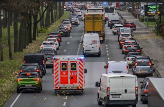 Rescue lane, ambulance making its way through city centre traffic with blue lights and siren,