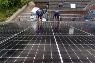 Installation of solar modules on the roof of a barn on a farm, over 240 photovoltaic modules are