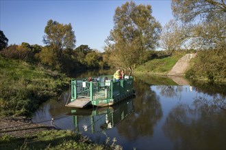 Cyclist, cycle tour, manually operated ferry across the Lippe near Halten am See, on the