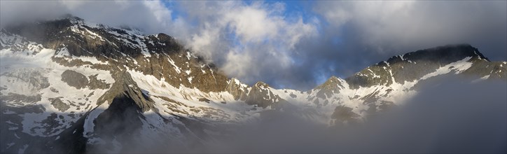 Panorama, cloudy atmospheric mountain landscape with summit Hochsteller and Griesferner with snow