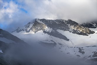 Cloudy glaciated summit Dosso Largo with glacier Schlegeiskees, Berliner Höhenweg, Zillertal Alps,