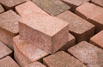 Clay bricks piled up in builder's yard, UK