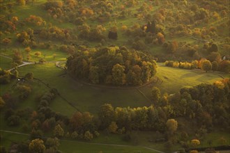 Volcanic embryo Hohbölle near Beuren. Autumnal Swabian Alb at sunset