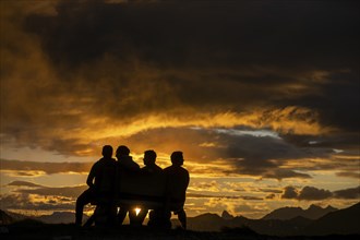 People marvelling at Montafon mountains with dramatic cloudy sky at sunset, Tschagguns, RÃ¤tikon,