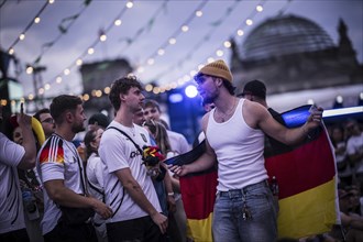 Scenes in the fan zone on Platz der Republik in front of the Reichstag building taken in Berlin, 29