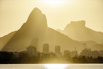 Sunset at the Rodrigo de Freitas lagoon in the city of Rio de Janeiro with the Gavea stone and Two