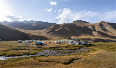 Yurts and historic caravanserai Tash Rabat from the 15th century, with yellow hills, Atbashy