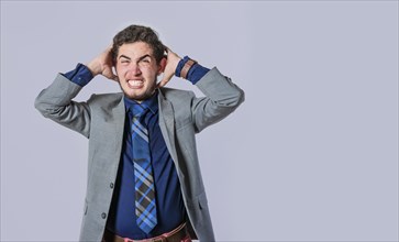 Frustrated businessman yelling, Man in suit screaming clutching his head, Desperate man yelling