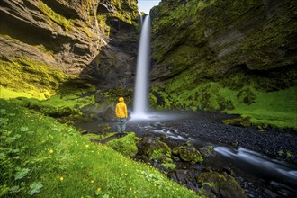 Tourist at Kvernufoss waterfall, in summer when the weather is nice, gorge and river, long