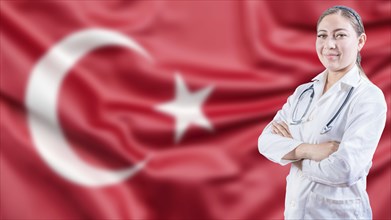 Portrait of doctor with crossed arms with Turkish flag in the background. Healthcare concept with