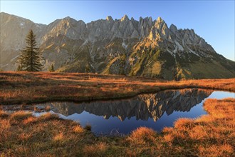 Rugged mountains reflected in a small mountain lake, autumn, evening light, Hochkönig, Mandlwand,