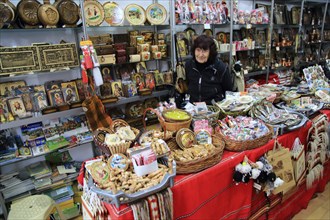 Woman shopkeeper standing in her souvenir gift shop, Plovdiv, Bulgaria, eastern Europe, Europe