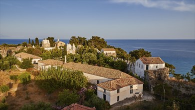 Panoramic view of houses with red gabled roofs and churches, sea, evening light, Koroni, Byzantine