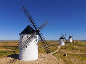 Traditional windmills in an open field under a clear blue sky, Mills, Alcazar de San Juan, PaÃ­s de